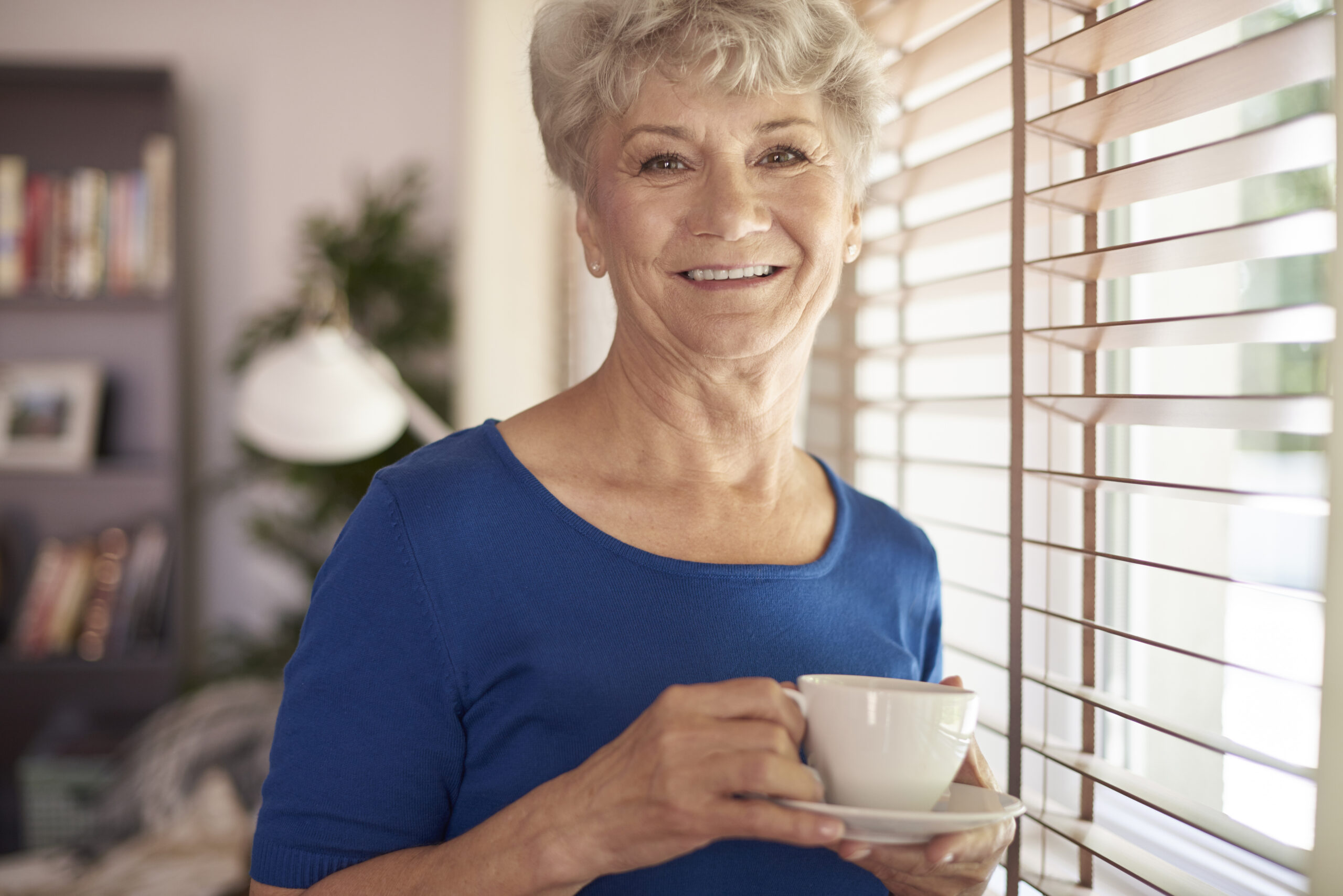 Elderly woman enjoying a peaceful moment at home